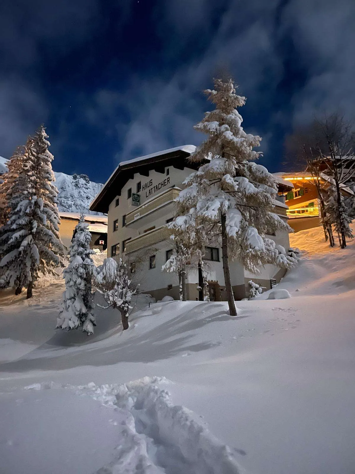 The Arlberg Motel on a winter night, deep snow in front