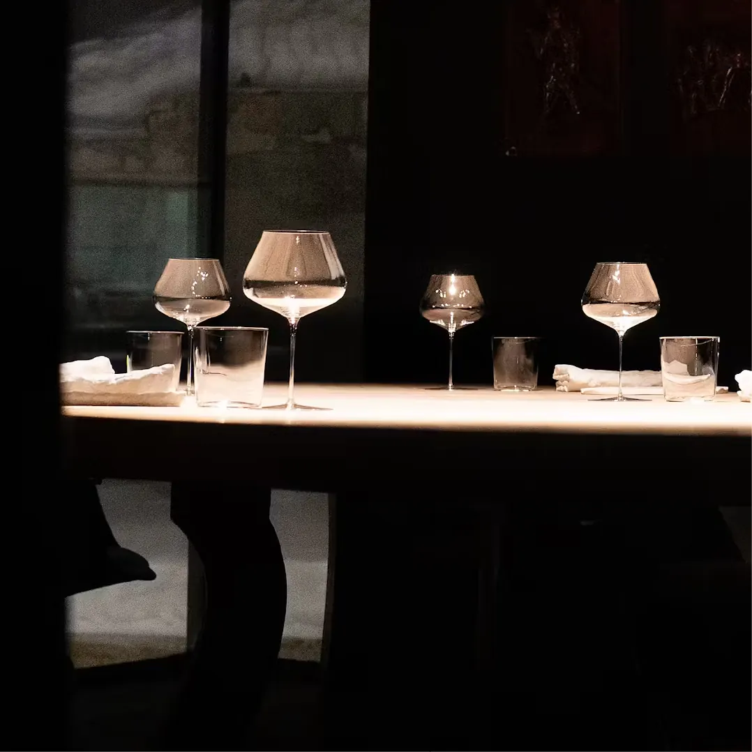 Wine glasses on a lit table